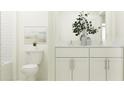 Bright bathroom featuring double sinks with white cabinetry, modern fixtures, and decorative elements at 8440 Sea Ray Run, Parrish, FL 34219