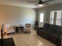 Inviting living room featuring tile floors, a ceiling fan, and comfortable seating at 10126 Bahama Ct, Seminole, FL 33776