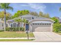 Charming single-story home with lush landscaping, two car garage and freshly cut lawn at 10641 Firebrick Ct, Trinity, FL 34655