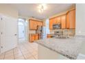 The kitchen features stainless steel appliances, granite countertops, and a tile floor at 10641 Firebrick Ct, Trinity, FL 34655