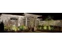 Charming home exterior featuring decorative stone, arched entry and lush landscaping with exterior night lighting at 13553 Landers Dr, Hudson, FL 34667