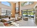Inviting living room with water views from the screened in porch and brick fireplace at 2199 Springrain Dr, Clearwater, FL 33763