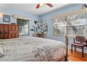 Serene bedroom with hardwood floors, light blue walls, and lots of natural light at 225 Garden S Cir, Dunedin, FL 34698