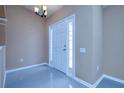 Inviting entryway with beautiful tile flooring and sidelights that frame the front door at 25323 Lexington Oaks Blvd, Wesley Chapel, FL 33544