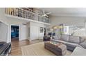 Bright living room featuring high ceilings, wood floors, loft, and ample natural light at 2572 Forest Run Ct, Clearwater, FL 33761
