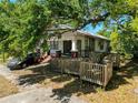 Exterior showcases a wraparound deck and a mature tree providing plenty of shade at 3106 E 25Th Ave, Tampa, FL 33605