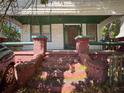 Home's entrance featuring brick columns and steps, creating a warm and inviting appeal at 3106 E 25Th Ave, Tampa, FL 33605