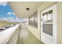 Balcony view of unit 305 with a white security door and a view of the parking lot at 4885 1St Ne St # 305, St Petersburg, FL 33703