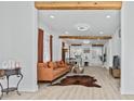 Spacious living room featuring wood beam accents, modern lighting, and an open floor plan at 5108 N Suwanee Ave, Tampa, FL 33603
