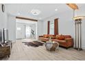 Bright and airy living room featuring hardwood floors, neutral walls, and stylish furniture at 5108 N Suwanee Ave, Tampa, FL 33603