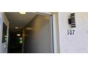 Welcoming entrance featuring unit number and light fixture, leading into a bright interior at 5725 80Th N St # 107, St Petersburg, FL 33709