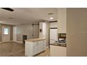Open kitchen featuring white cabinets, butcher block island, and stainless steel appliances at 5725 80Th N St # 107, St Petersburg, FL 33709