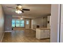 Spacious living room featuring tile floors, ceiling fans, and abundant natural light at 5725 80Th N St # 107, St Petersburg, FL 33709