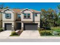 Beautiful two-story townhome with a well-maintained lawn, mature trees, and a two car garage at 6732 Rocky Park St, Tampa, FL 33625