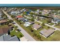 Aerial shot showcasing a waterfront community with homes, canals, and a glimpse of the open water in the distance at 7322 Mako Dr, Hudson, FL 34667