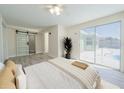 A spacious main bedroom features a sliding barn door to the bathroom and large glass doors out to the pool at 7322 Mako Dr, Hudson, FL 34667