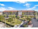 Beautiful exterior of Bridge Hampton Bay, featuring lush landscaping, palm trees, and a welcoming entrance at 8711 Blind Pass Rd # 207A, St Petersburg, FL 33706