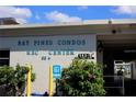 Exterior view of Bay Pines Condos Rec Center features lush landscaping and reserved accessible parking at 9815 47Th N Ave # 306, St Petersburg, FL 33708
