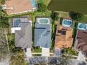 Aerial view of homes with screened-in pools and well-maintained yards in a residential neighborhood at 10220 Deercliff Dr, Tampa, FL 33647