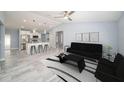Bright, open-concept living room featuring modern decor and a view into the kitchen at 105 2Nd Ne Ave, Lutz, FL 33549