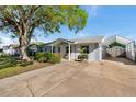 Street view of the house showing landscaping, carport and front yard at 10709 Airview Dr, Tampa, FL 33625