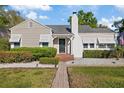 Charming single-Gathering home with a well-manicured lawn, brick walkway, and inviting entrance at 108 S Lincoln Ave, Tampa, FL 33609