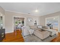 Spacious living room with hardwood floors, ceiling fan, and comfortable sectional sofa at 108 S Lincoln Ave, Tampa, FL 33609