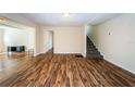 Spacious living room showcasing hardwood floors and access to the upper level at 1104 E Genesee St, Tampa, FL 33603