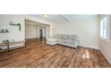 Comfortable living room with hardwood floors and a sectional couch, perfect for relaxing at 1104 E Genesee St, Tampa, FL 33603