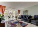 Cozy living room featuring a large window with a view, comfortable seating, and stylish decor at 14130 Rosemary Ln # 1201, Largo, FL 33774
