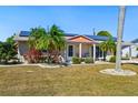 Charming single-story home with mature landscaping, solar panels and a welcoming front porch at 1515 Arrowhead Dr, Sun City Center, FL 33573