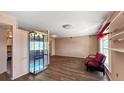 Open-concept living space with wood flooring, a modern display case, and a cozy seating area at 1515 Arrowhead Dr, Sun City Center, FL 33573