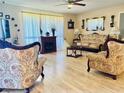 Elegant living room featuring decorative furniture, a cozy fireplace, and soft, natural light at 1516 Arrowhead Dr, Sun City Center, FL 33573