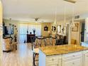 Spacious living area connected to kitchen, showcasing ornate furnishings and a relaxed atmosphere at 1516 Arrowhead Dr, Sun City Center, FL 33573