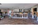 Spacious open floorplan under renovation with wood flooring, partial framing, and open kitchen area at 1591 N Dakota Ne Ave, St Petersburg, FL 33703