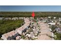 Beautiful aerial view of this community showing the tile roofs and mature trees and shrubbery throughout at 1806 Lago Vista Blvd, Palm Harbor, FL 34685