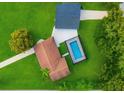 An aerial view shows a backyard oasis, complete with screened pool, and lush landscaping at 20 2Nd Se Ave, Lutz, FL 33549