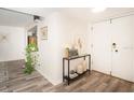 Inviting entryway with wood-look flooring, console table, and modern decor at 220 Belleview Blvd # 701, Belleair, FL 33756