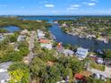 Expansive aerial view of waterfront property with lush landscaping and bay views in a desirable neighborhood at 292 Sunlit Cove Ne Dr, St Petersburg, FL 33702