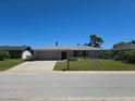 Inviting one-story home featuring an attached garage and lush green lawn at 3122 Egret Ter, Safety Harbor, FL 34695