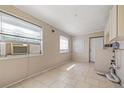 Bright laundry room features tile floors, a window, and access to the exterior with washer/dryer hookups at 3256 Roxborough Ave, Clearwater, FL 33762