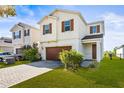 Attractive home showcasing a paver driveway, well-maintained lawn, and warm, inviting colors at 34024 White Fountain Ct, Wesley Chapel, FL 33545