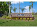 Stone community sign for Cypress Meadows, a deed-restricted community, set among landscaped greenery at 3627 Cypress Meadows Rd, Tampa, FL 33624