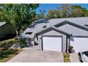 Street view of a well kept home with an attached garage and neat landscaping at 39650 Us Highway 19 N # 411, Tarpon Springs, FL 34689