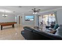 Relaxing living area with leather sofa, large TV, and sliding door access to the lanai at 4219 Summerdale Dr, Tampa, FL 33624
