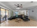 Spacious living room with dark leather furniture, large mirror, and access to an outdoor lanai at 4219 Summerdale Dr, Tampa, FL 33624