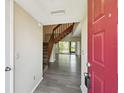 Bright foyer with wood-look flooring, stairs, and a view into the living space at 440 Woods Landing Trl, Oldsmar, FL 34677
