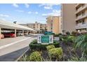 Building entrance featuring covered parking and manicured landscaping at 4460 Fairways Blvd # 401, Bradenton, FL 34209