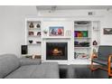 Cozy living room with a fireplace, built-in shelving, and comfortable seating at 4950 Bayshore Blvd # 14, Tampa, FL 33611
