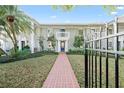 Beautiful townhouse with a red brick pathway and lush green lawn at 5011 S Elberon St, Tampa, FL 33611
